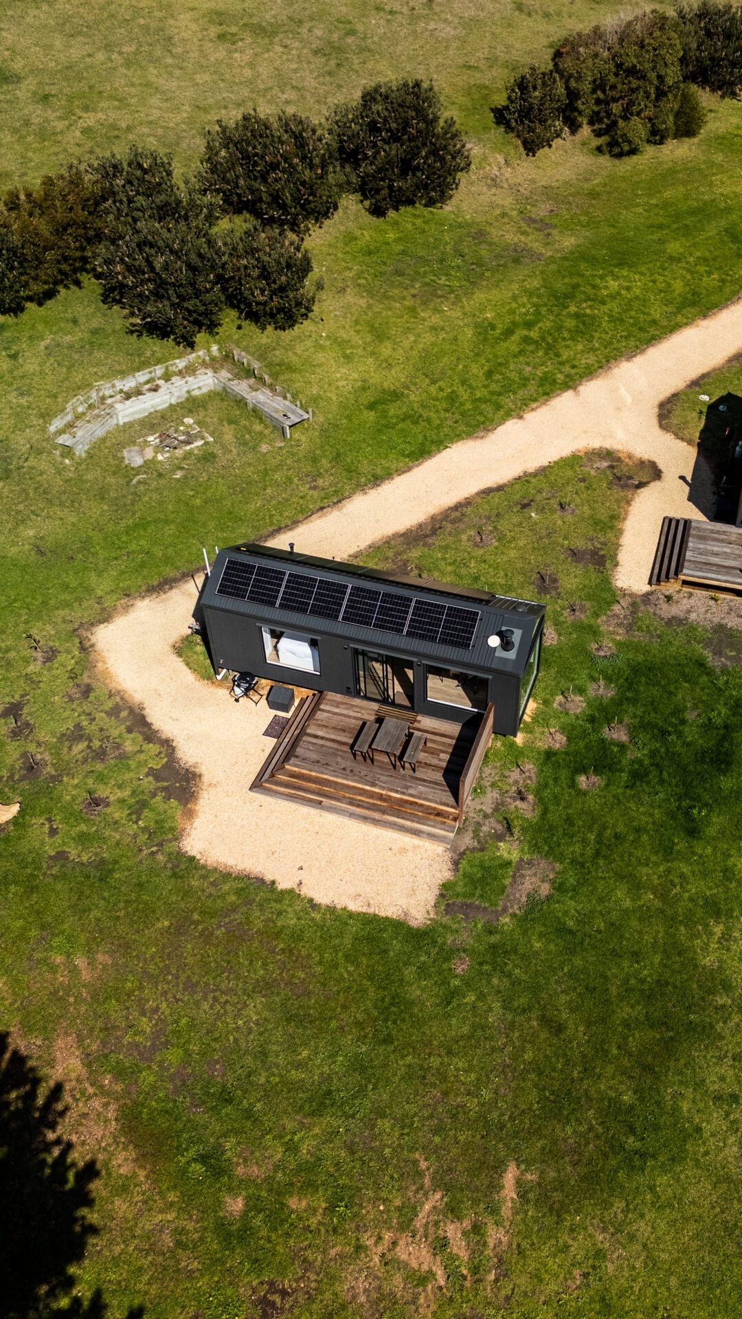 Aerial view of an off-grid cabin with rooftop solar